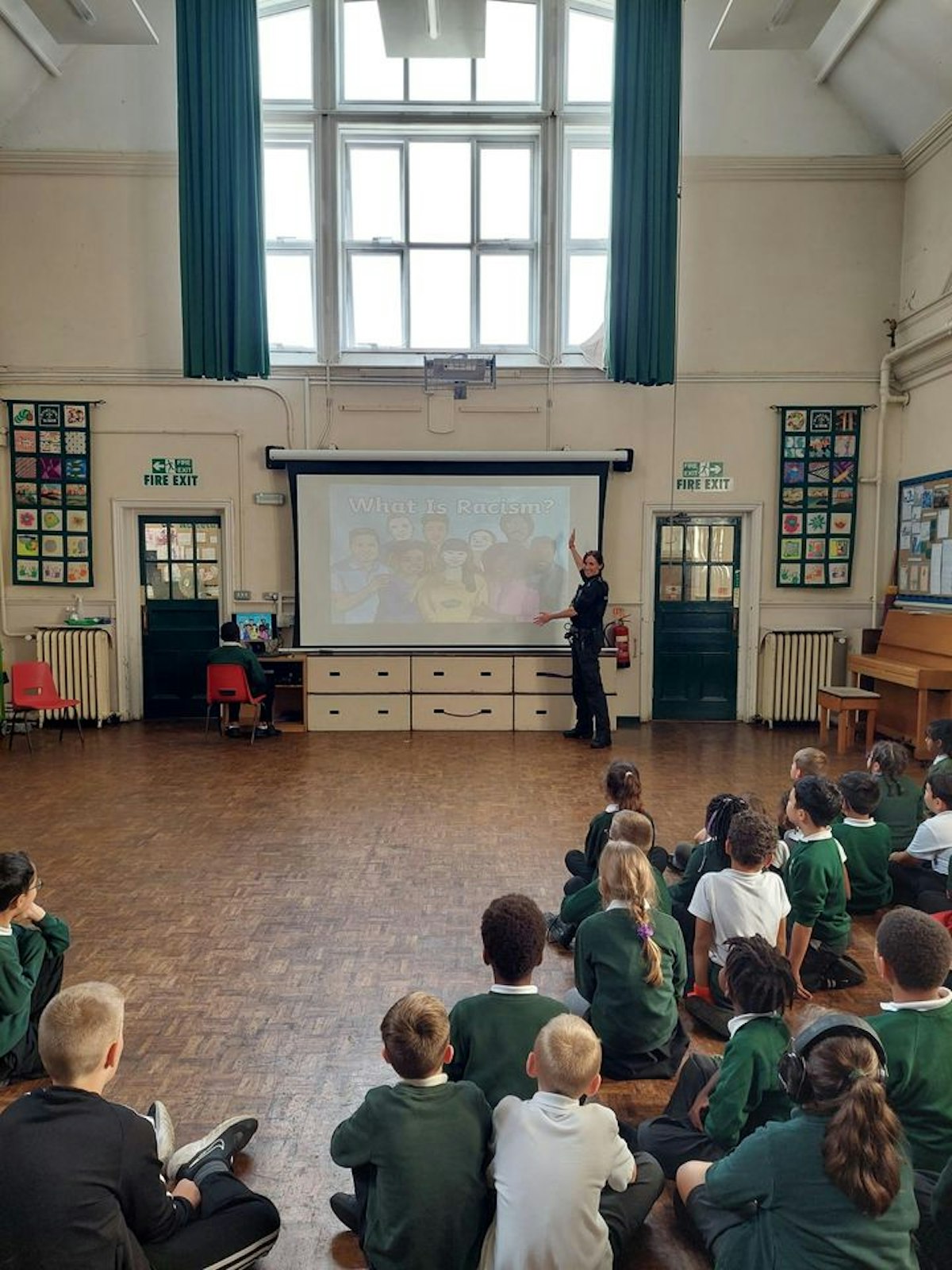 PC Sam speaking to pupils at a school